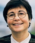 F. Isabel Campoy wearing glasses and smiling at the camera