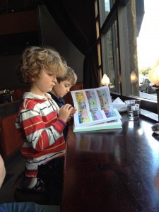 A small child sitting at a table reading