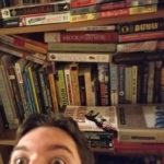 A person in front of a book shelf