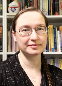 in front of a book shelf, Svetlana Chmakova