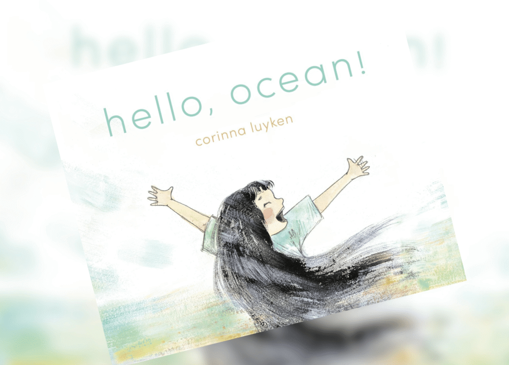 Illustrated book cover: a girl with arms raised in a watercolor scene, the title ‘hello, ocean!’ and author corinna luyken below it