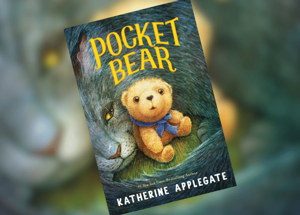Book cover for 'Pocket Bear' by Katherine Applegate, featuring a golden teddy bear with a blue scarf against a large wolf's fur background.