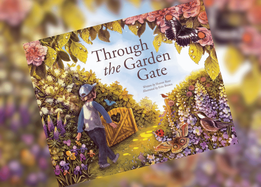 Through the Garden Gate Header | The Children's Book Review Illustrated children's book cover titled Through the Garden Gate, showing a boy in a blue shirt and hat in a colorful garden with flowers and butterflies.
